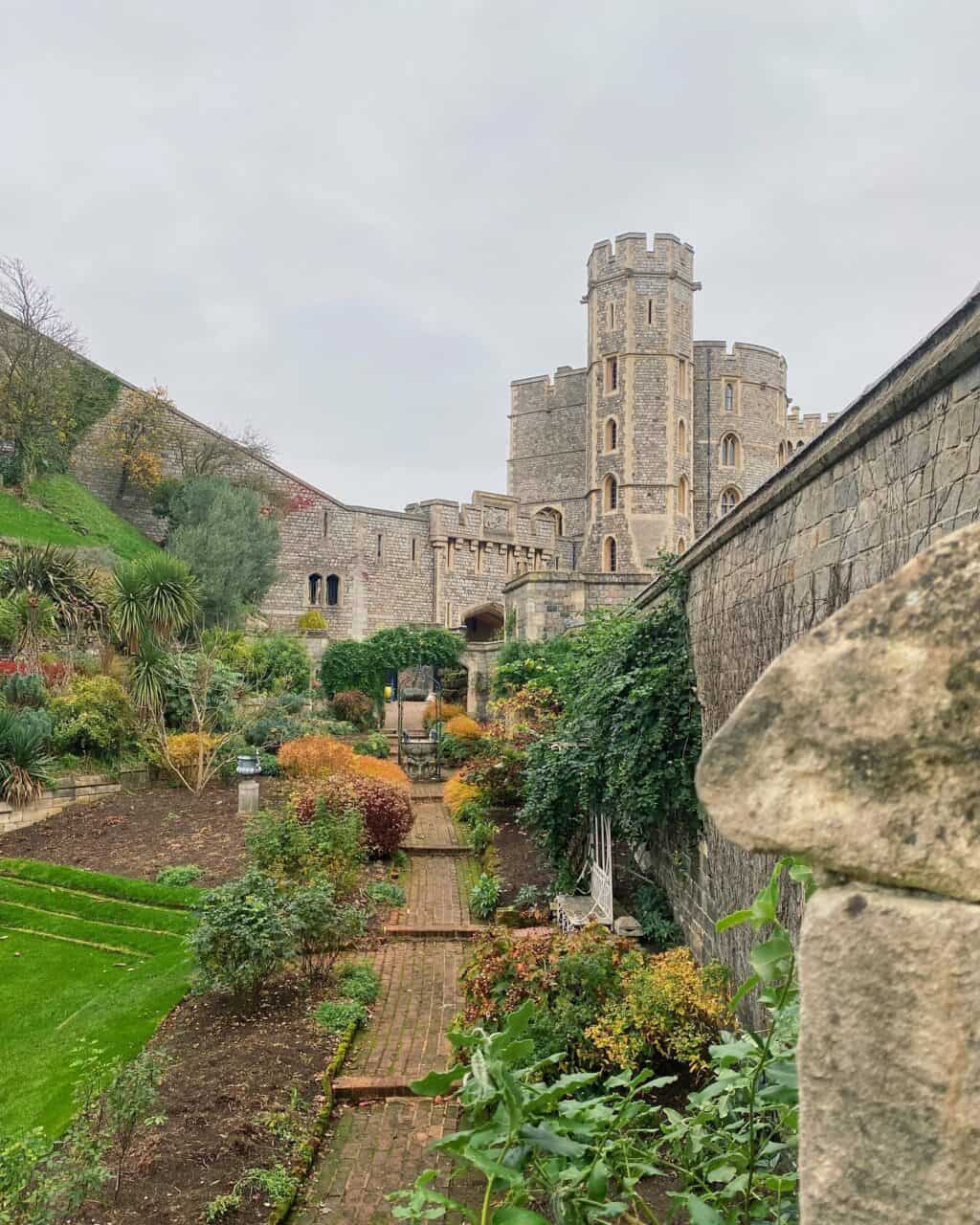 Historic Berlin castle with lush garden and stone walls.
