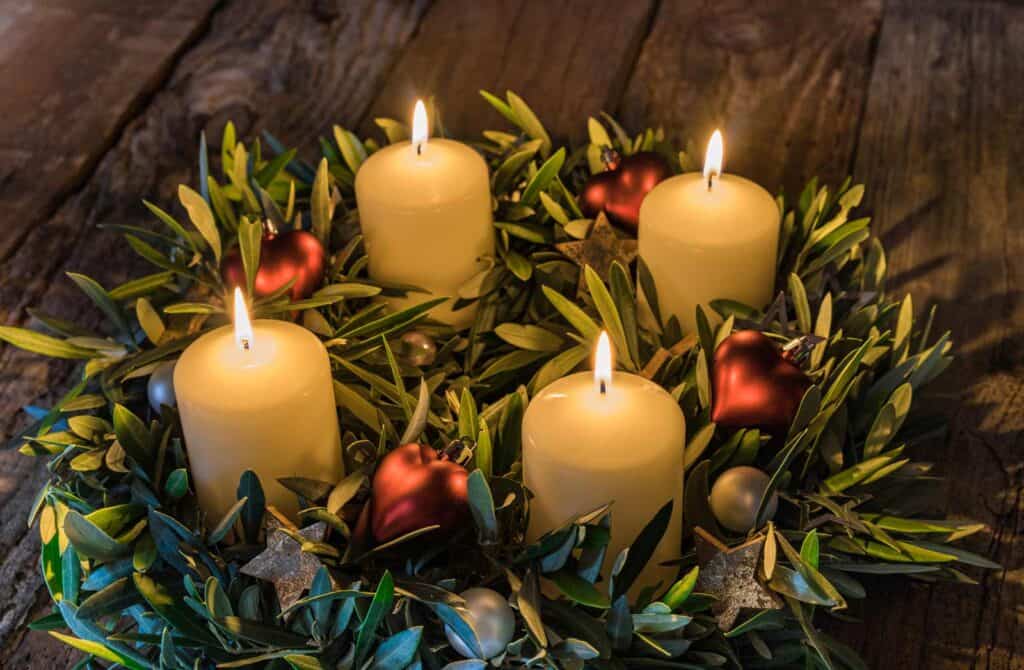 Decorative candle display with greenery and ornaments at Mitte Hostel, Berlin, perfect for holiday a.