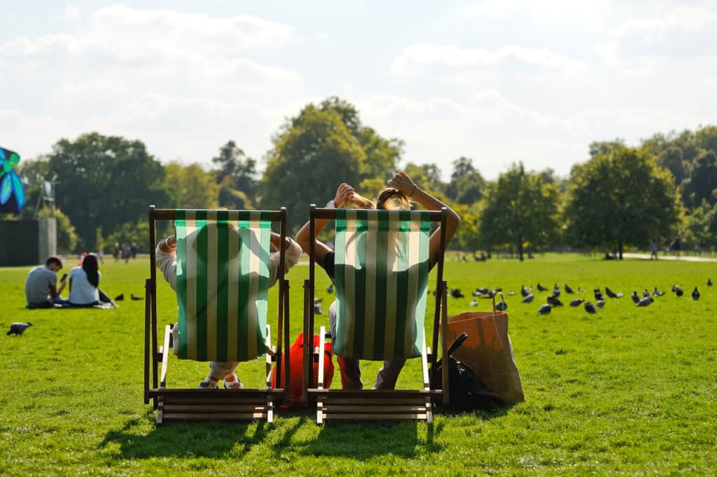 Relaxing in the park near Mitte Hostel Berlin, with two people sitting on deck chairs enjoying sunny.