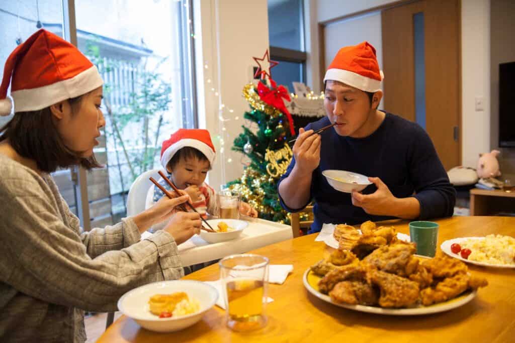 Family celebrating Christmas with festive food and decorations.