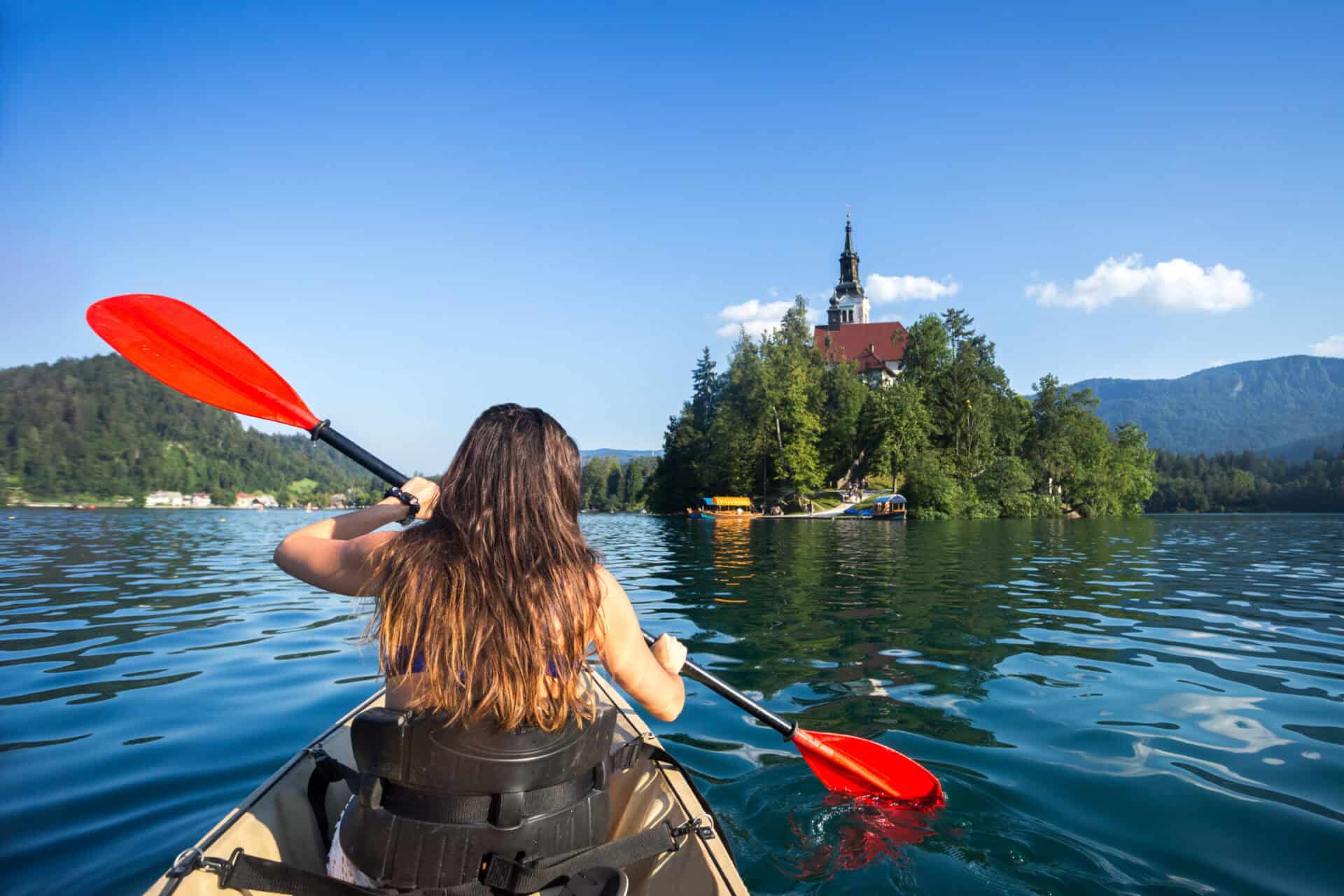 Kayaking on a serene lake with Berlin's Mitte Hostel in the background. Enjoy outdoor activities and.