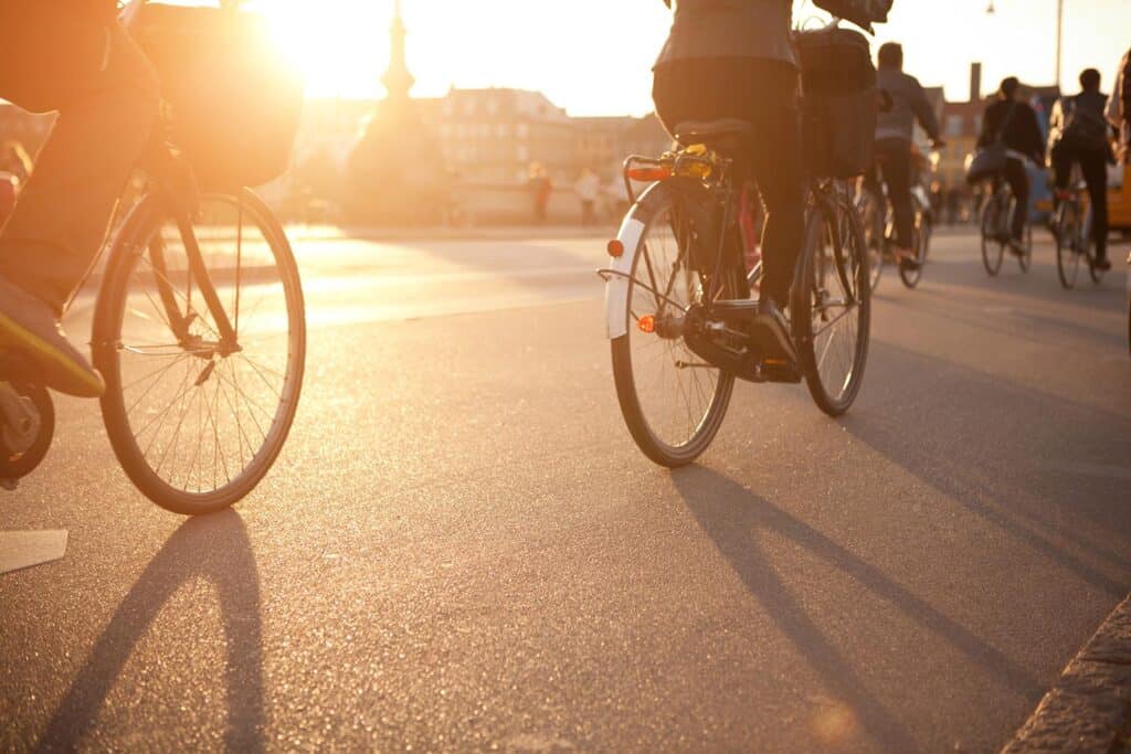 Cyclists riding bikes during sunset in Berlin Mitte, Germany.