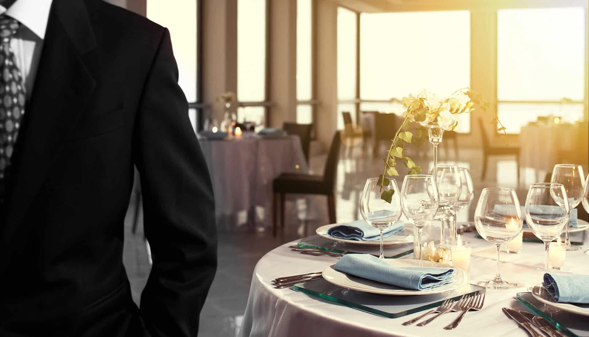 Elegant restaurant interior with neatly arranged tables, glassware, and floral centrepieces at St Ch.