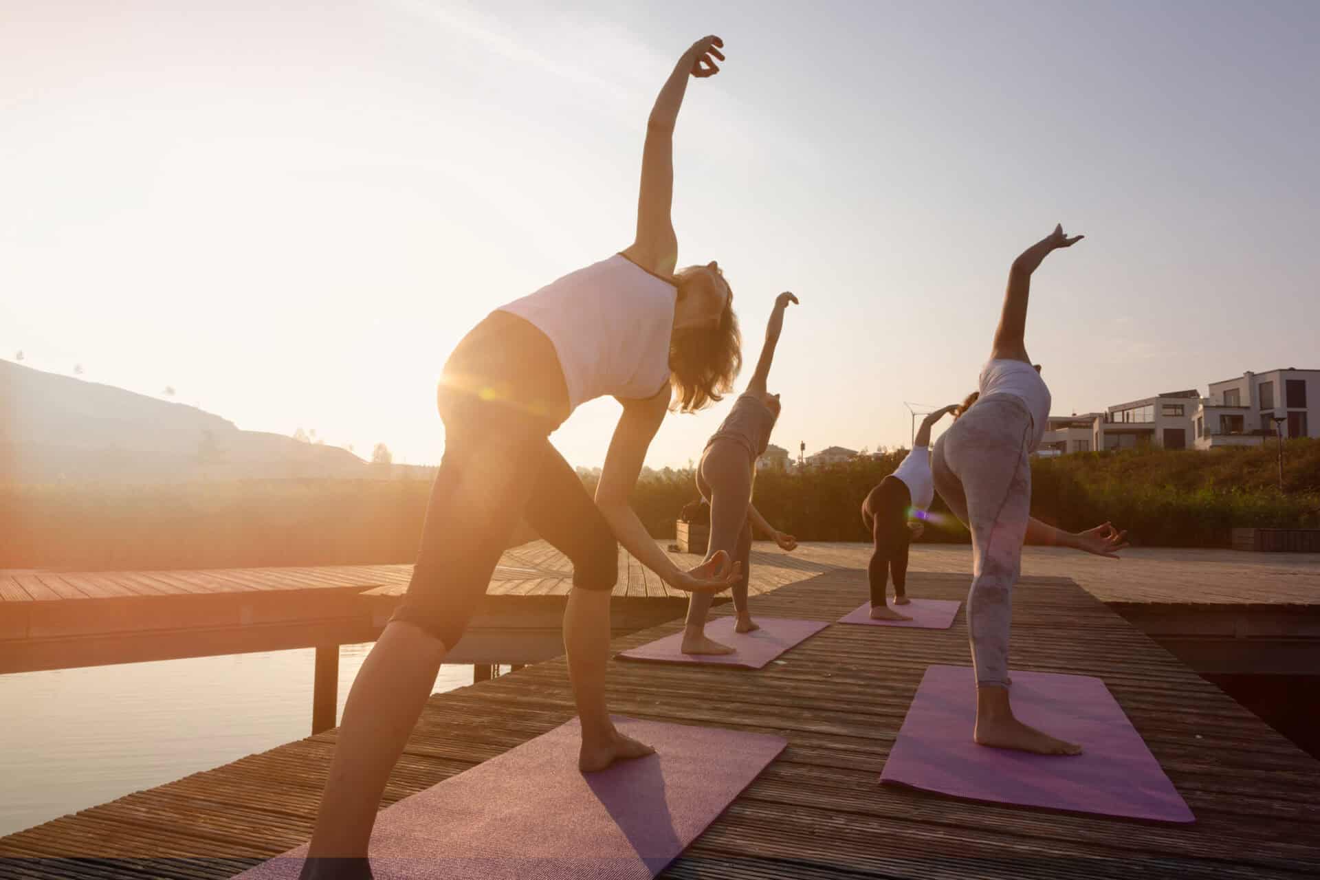 Yoga class at St Christopher’s Berlin - Mitte, outdoor on a wooden deck.