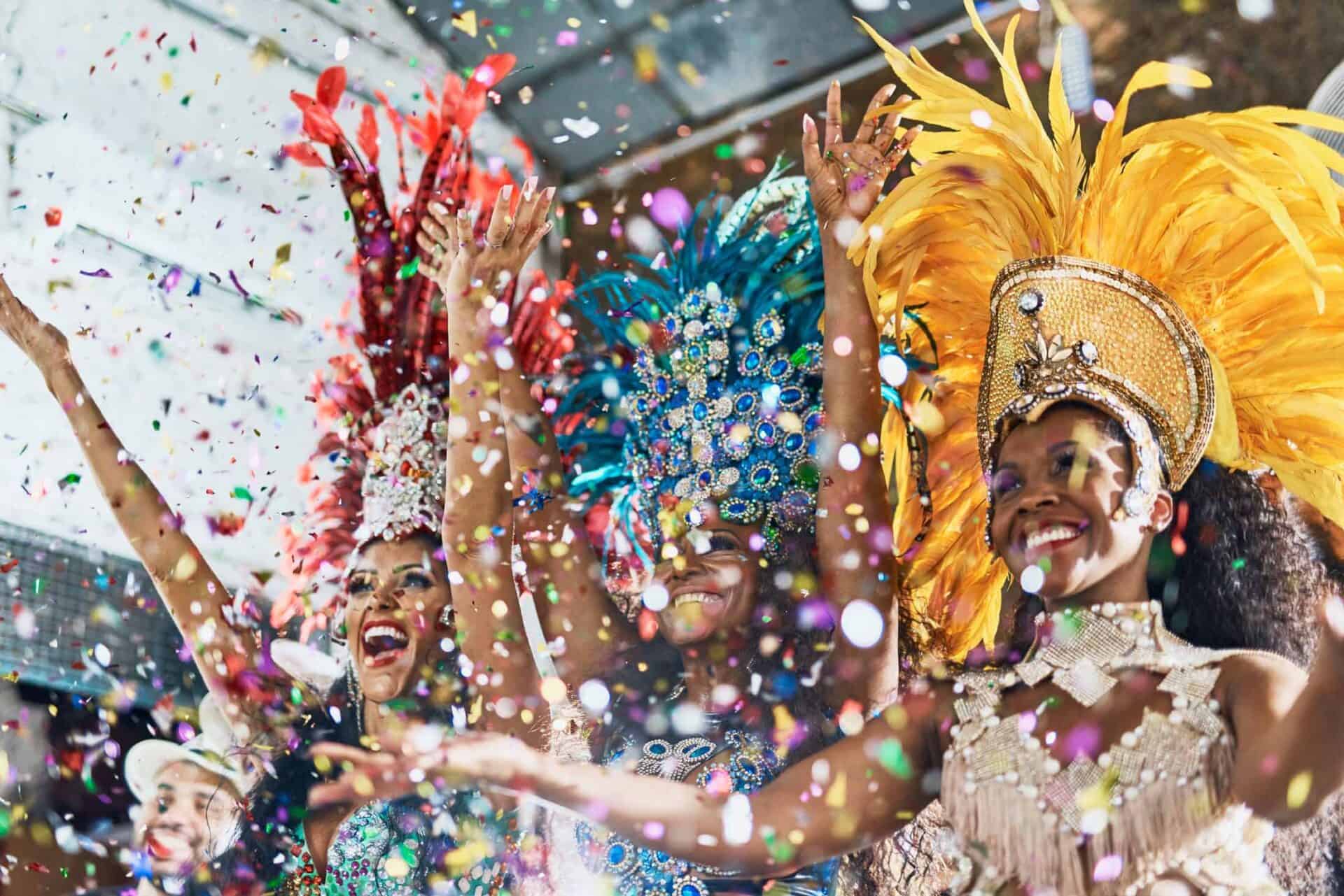 Vibrant carnival performers in colourful costumes celebrating with confetti at St Christopher’s Berl.