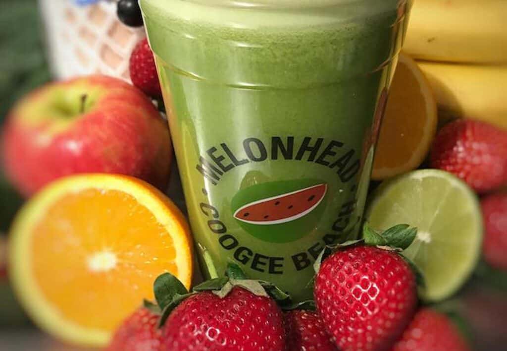 Green detox smoothie surrounded by fresh fruits at St Christopher’s Berlin - Mitte.