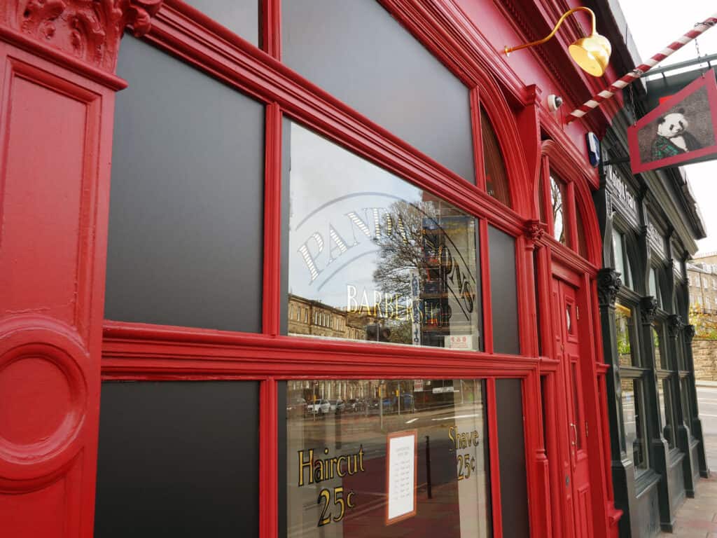 Exterior view of St Christopher’s Mitte Hostel in Berlin with red facade and signage.