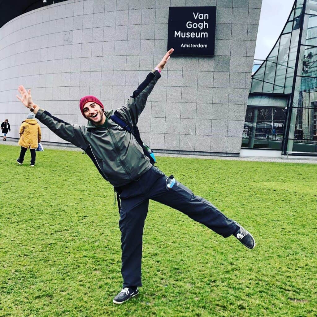 Happy traveler outside Van Gogh Museum in Berlin, enjoying the city.