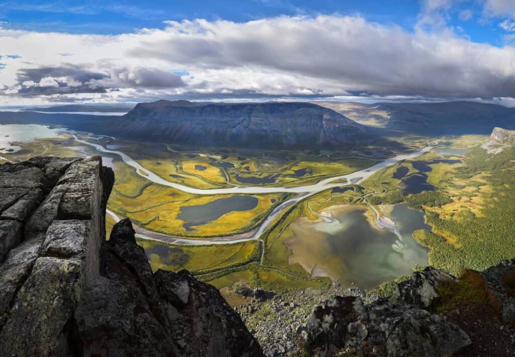 Breathtaking aerial view of Iceland's volcano, rivers, and lush green valleys.