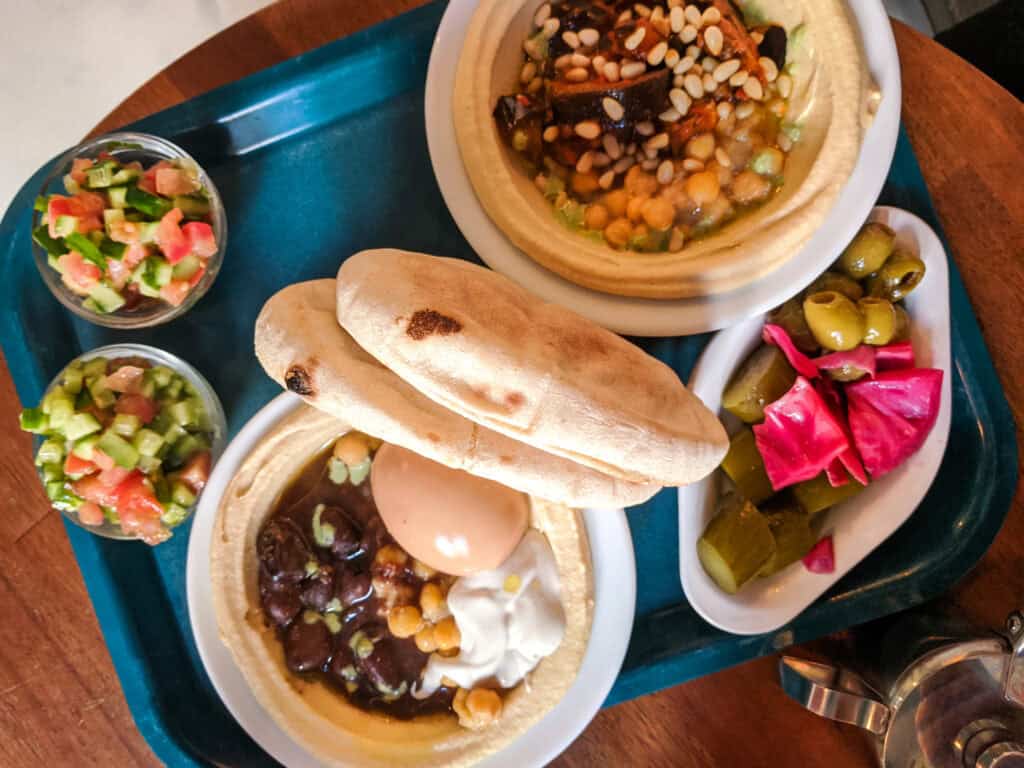 Delicious Middle Eastern mezze with hummus, falafel, pickles, and fresh vegetables at St Christopher.