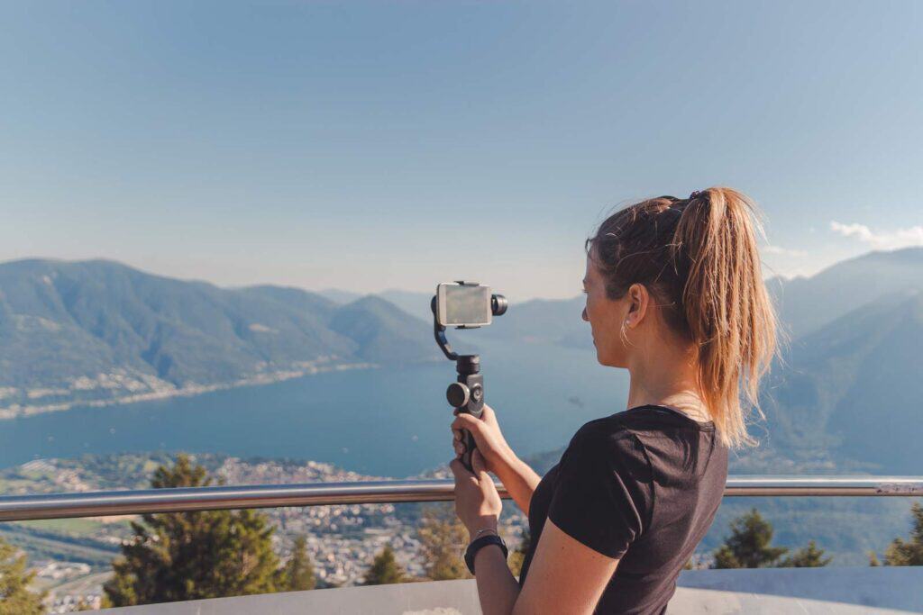 Woman taking a selfie with scenic Berlin city and lake view from Mitte hostel.