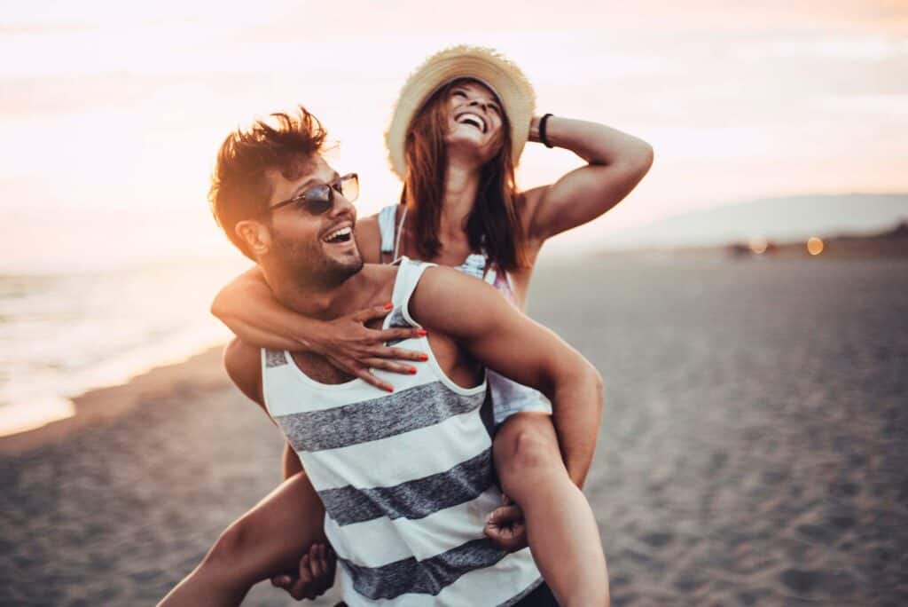 Happy couple at Berlin Mitte beach during sunset, enjoying summer and beach vibes.