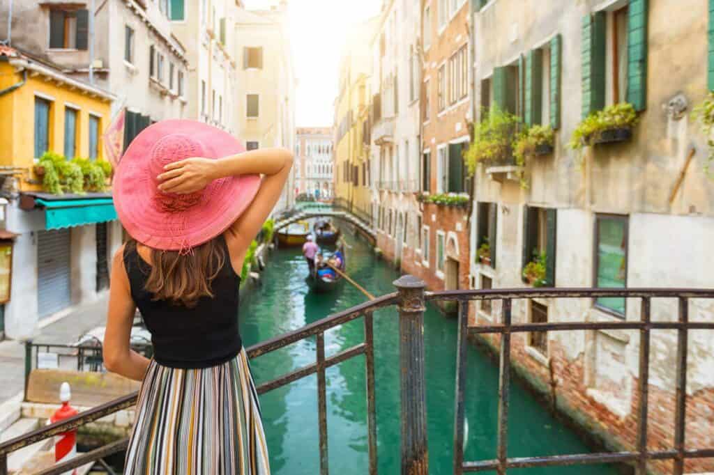 Woman overlooking a canal in Berlin's Mitte district with colourful buildings.