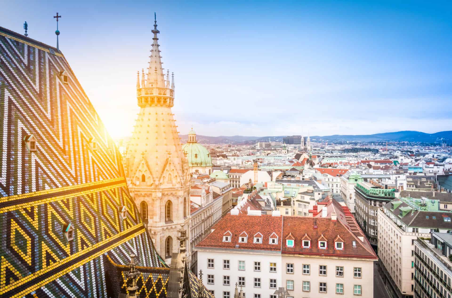 View of Berlin cityscape with historic architecture and rooftops at sunset.