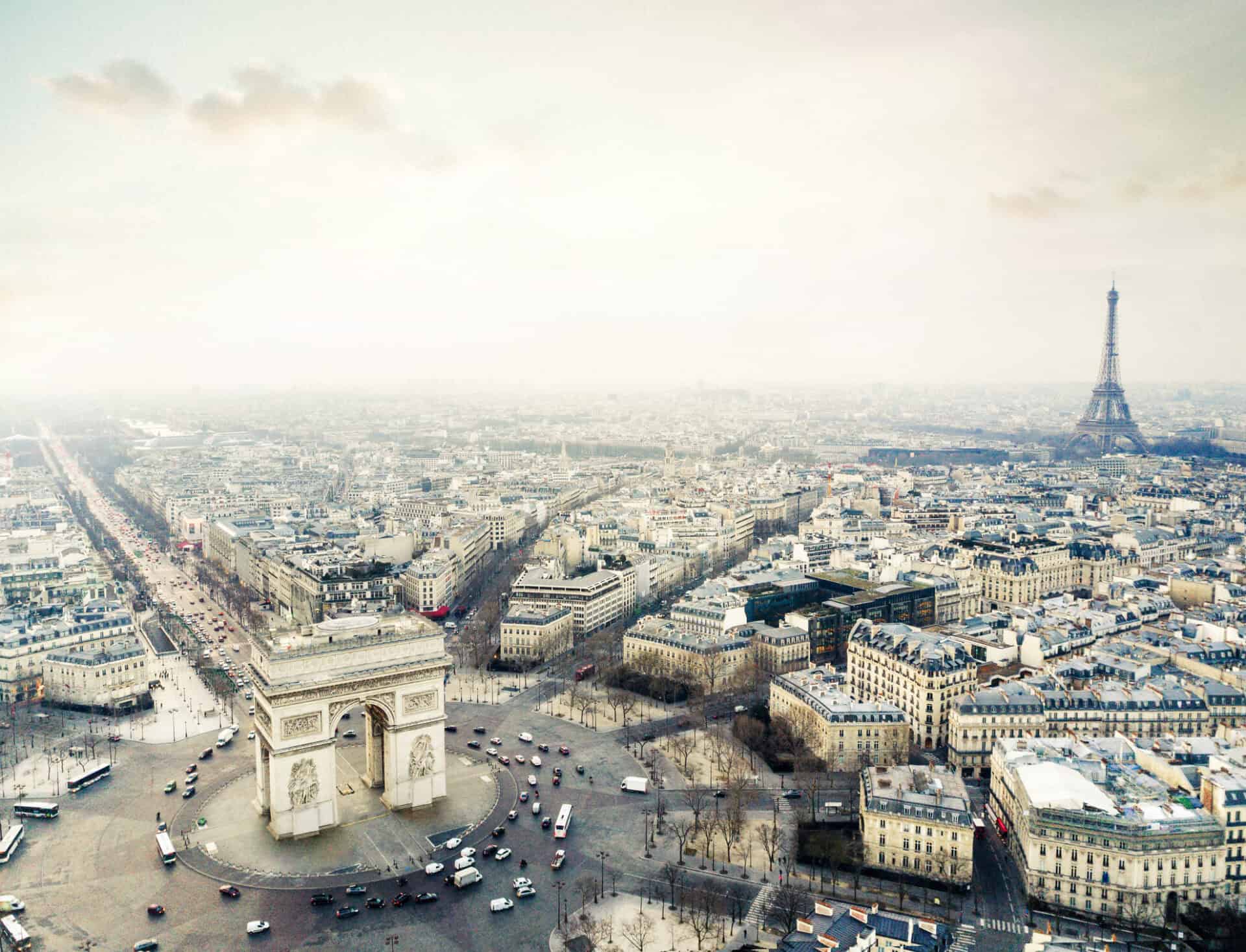 A cityscape view with the Eiffel Tower in the background and a busy roundabout in the foreground.