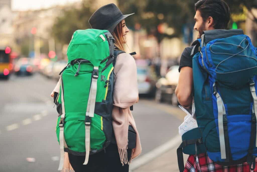 Two backpackers with large backpacks walking in Berlin city centre.