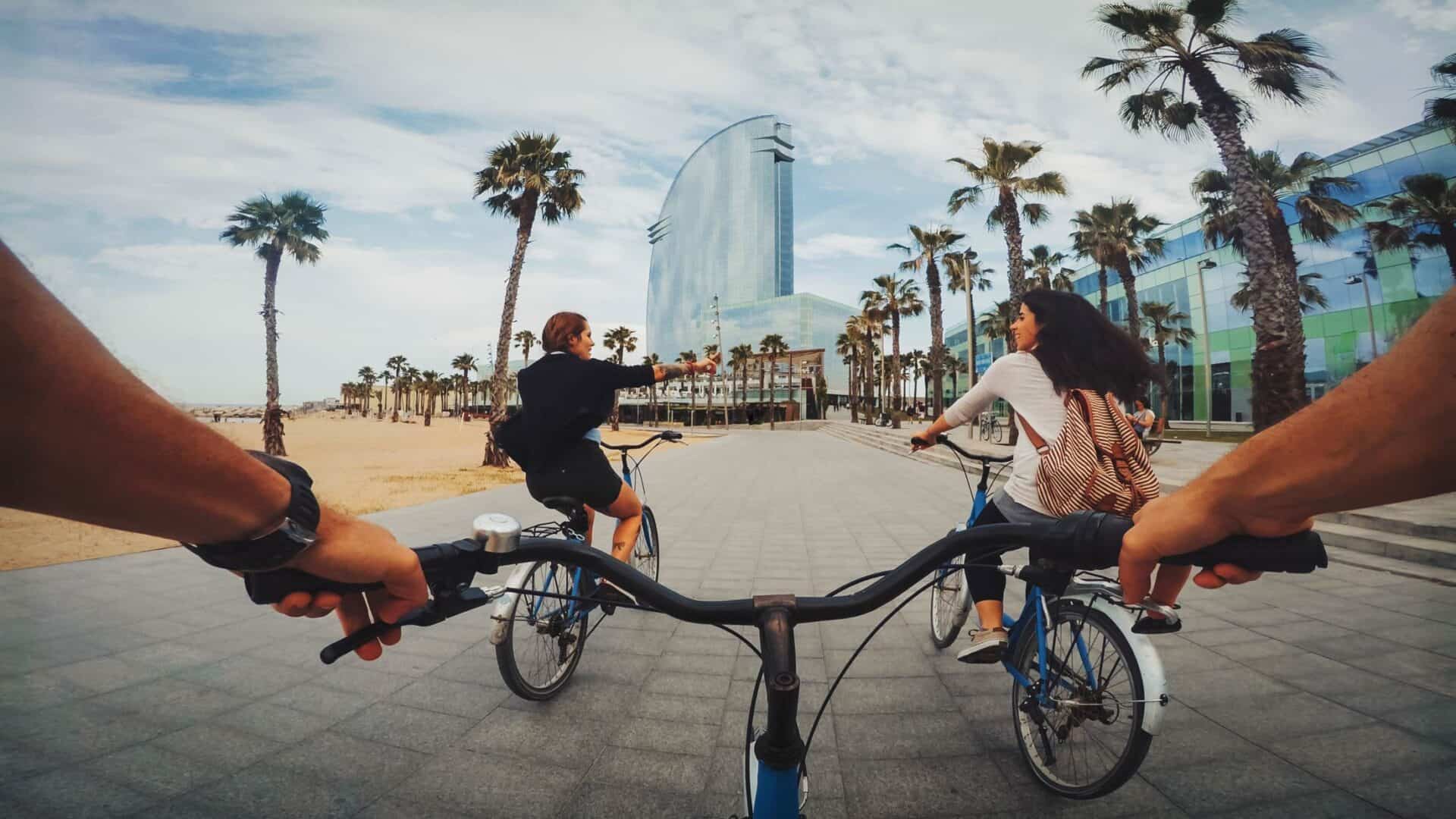 Cycling along Berlin's beach promenade with palm trees and contemporary architecture.