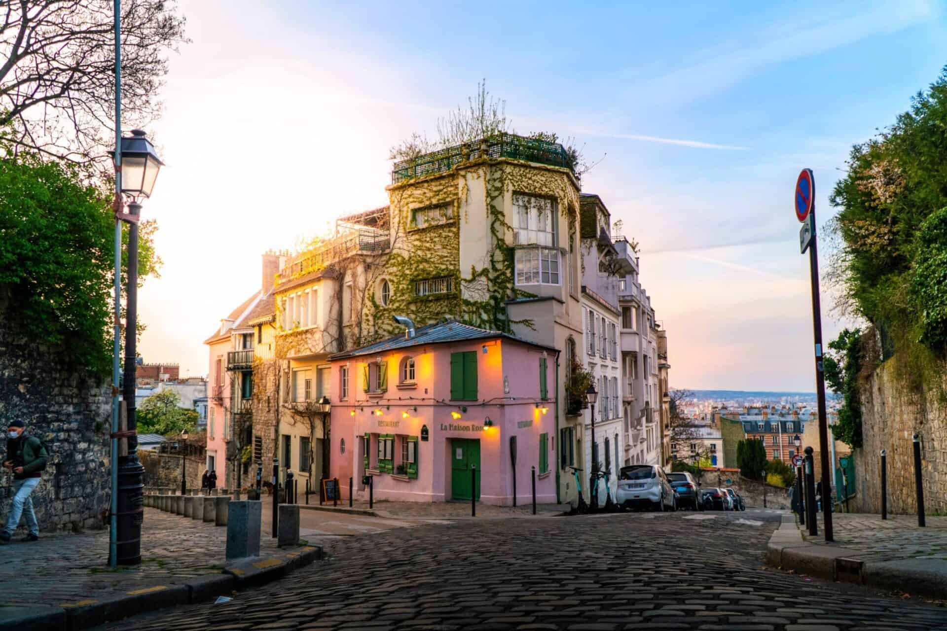 Historic Parisian building with ivy-covered facade at sunset, showcasing classic architecture.