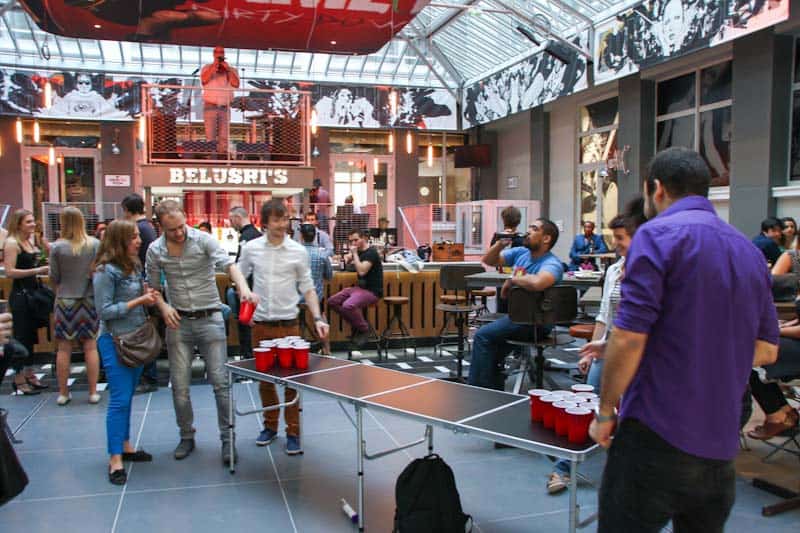 Vibrant social scene at St Christopher’s Berlin hostel in Mitte with guests playing table tennis and.