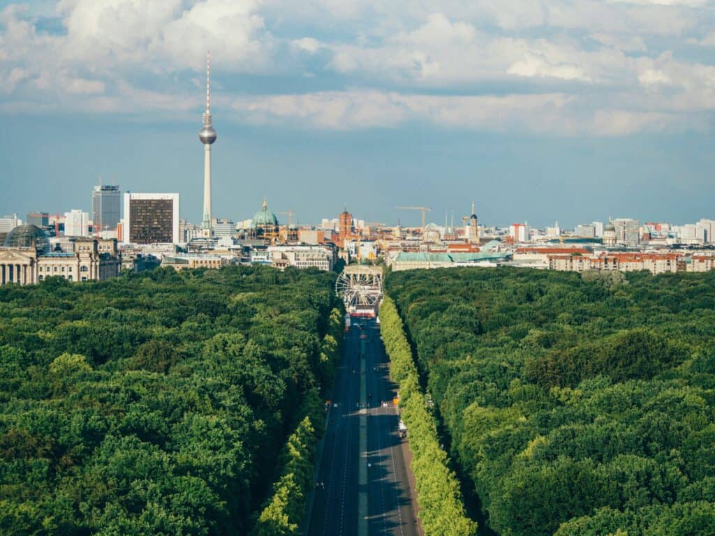 Berlin city skyline with TV Tower and lush green park, view from Mitte.