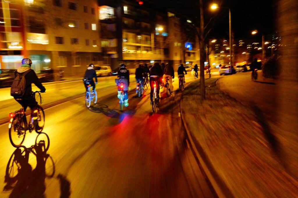 Night cycling in Berlin's Mitte district with illuminated streets and city lights.