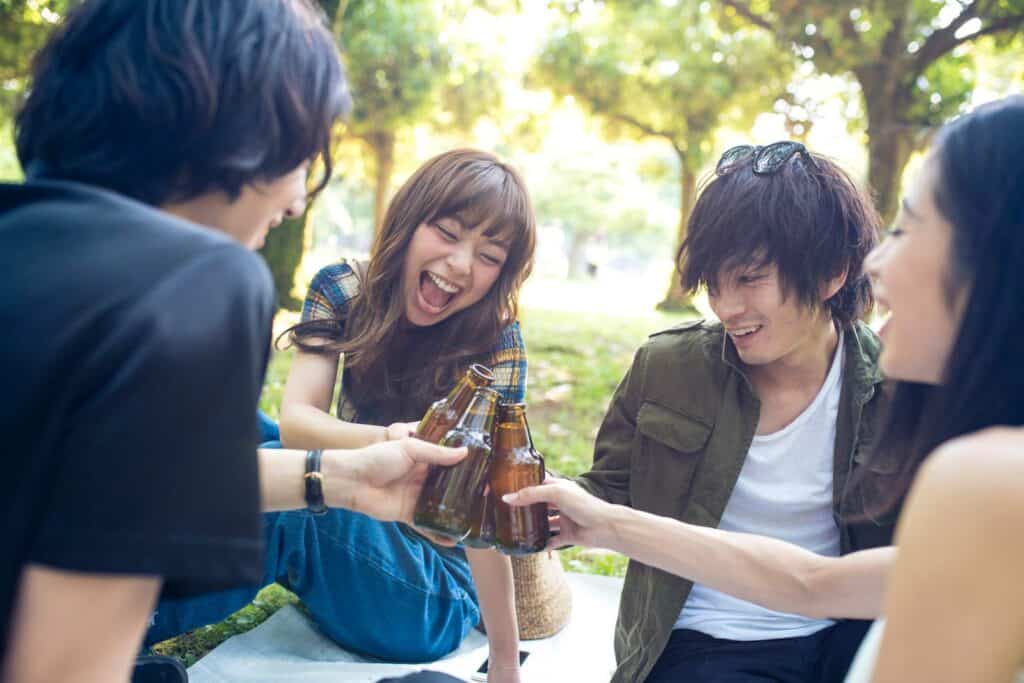 Group of young friends enjoying drinks together outdoors in Berlin's Mitte district.