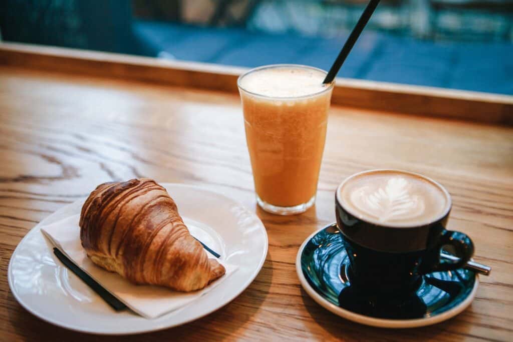Fresh coffee, orange juice, and croissant at Mitte Hostel, Berlin.