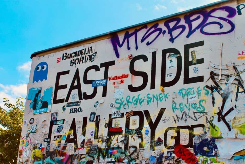 Graffiti artwork on the Berlin East Side Gallery near Mitte Hostel, showcasing vibrant street art.