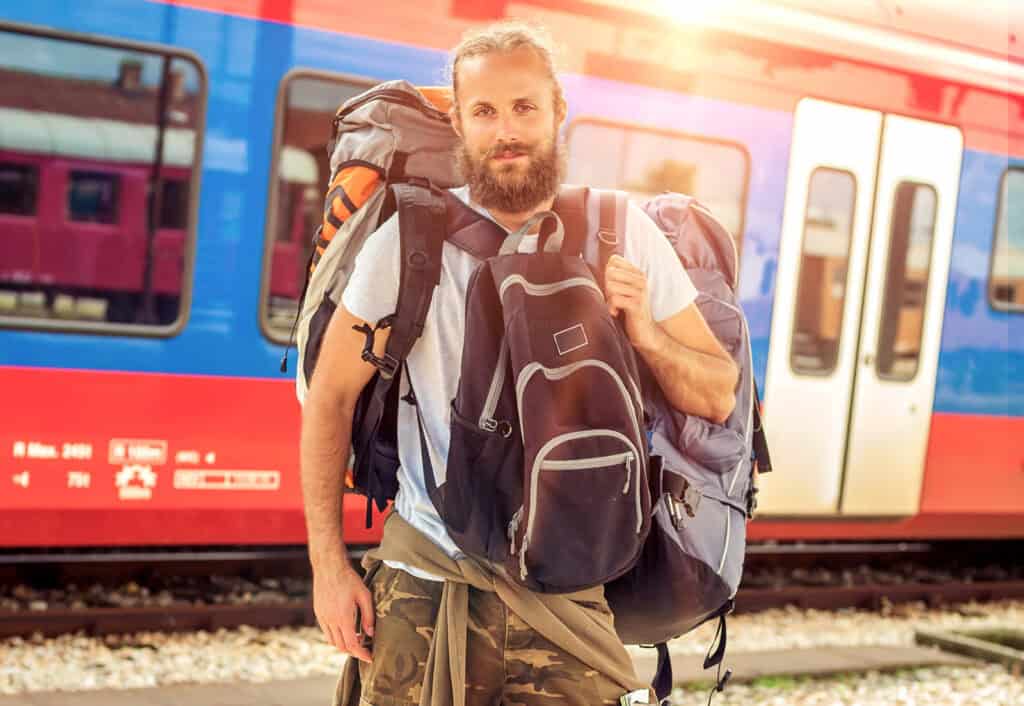 Young man with backpack at Berlin Mitte train station, travel, hostel, backpacker, Germany.