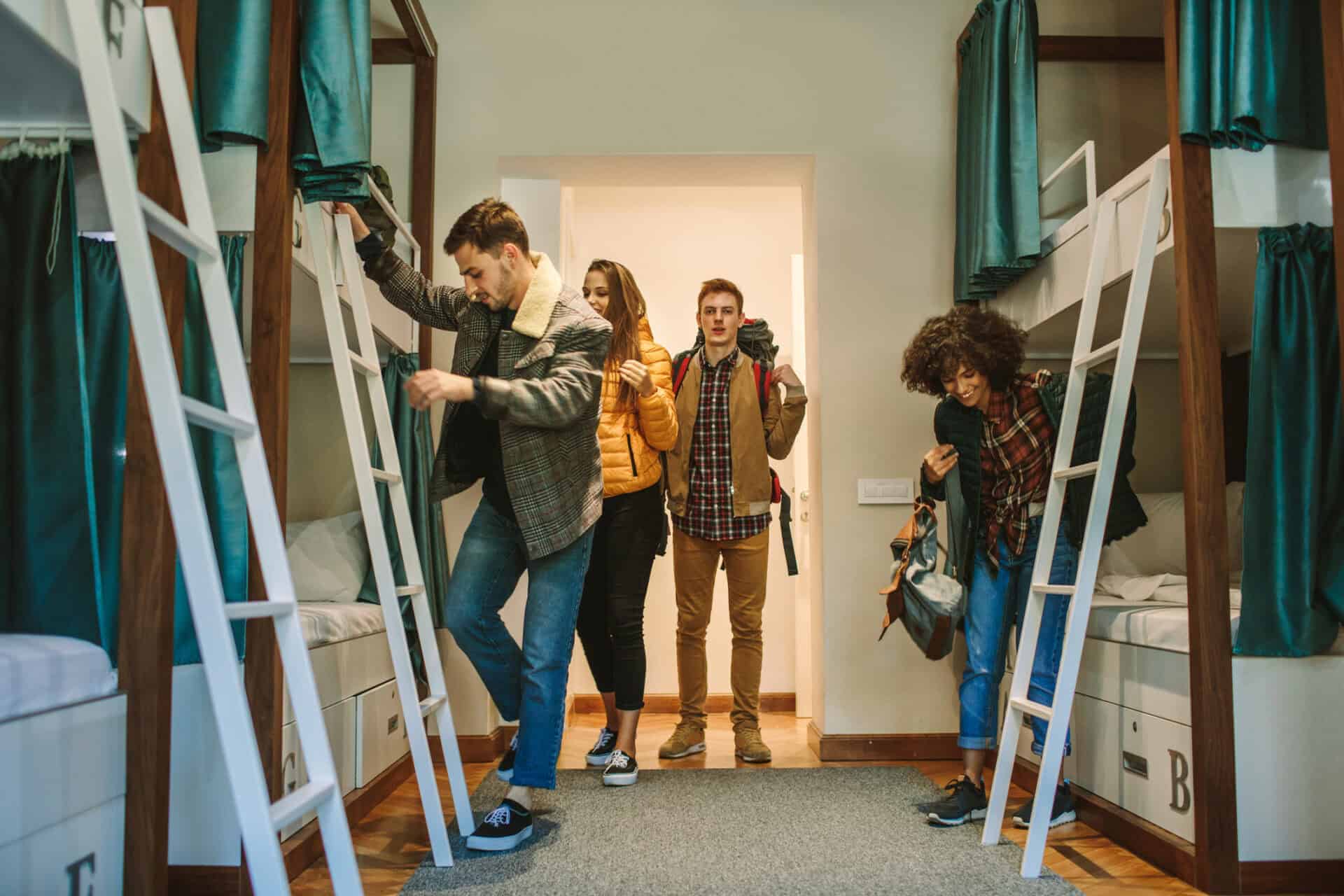 A dorm room in a St Christopher's Inn with bunk beds and travellers.