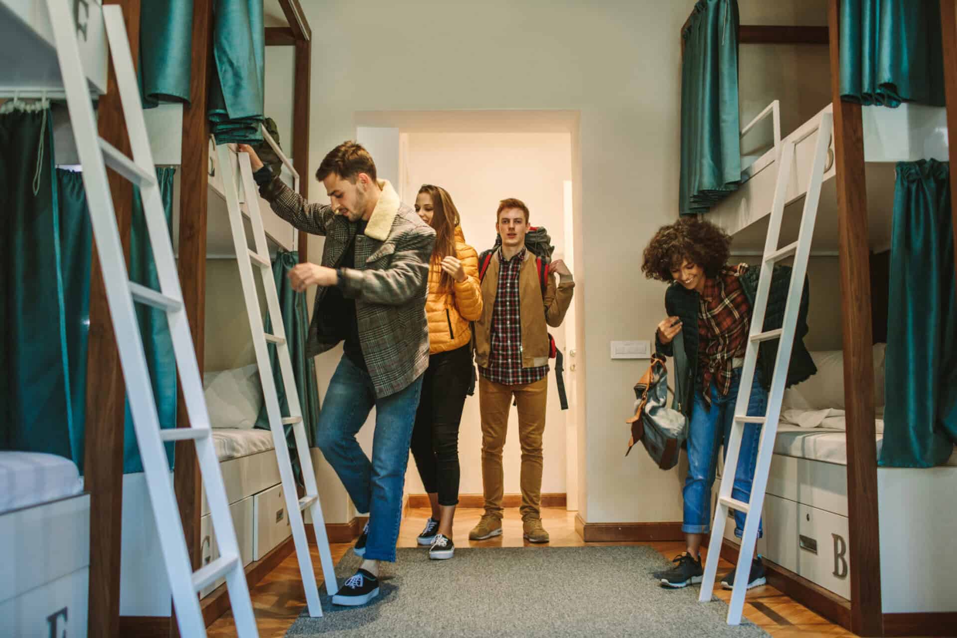Young travellers exploring hostel dorm beds at St Christopher’s Berlin Mitte.