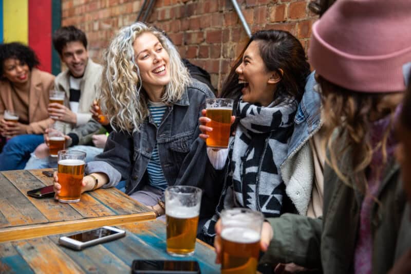 Group of friends enjoying drinks at a lively bar in Berlin Mitte.