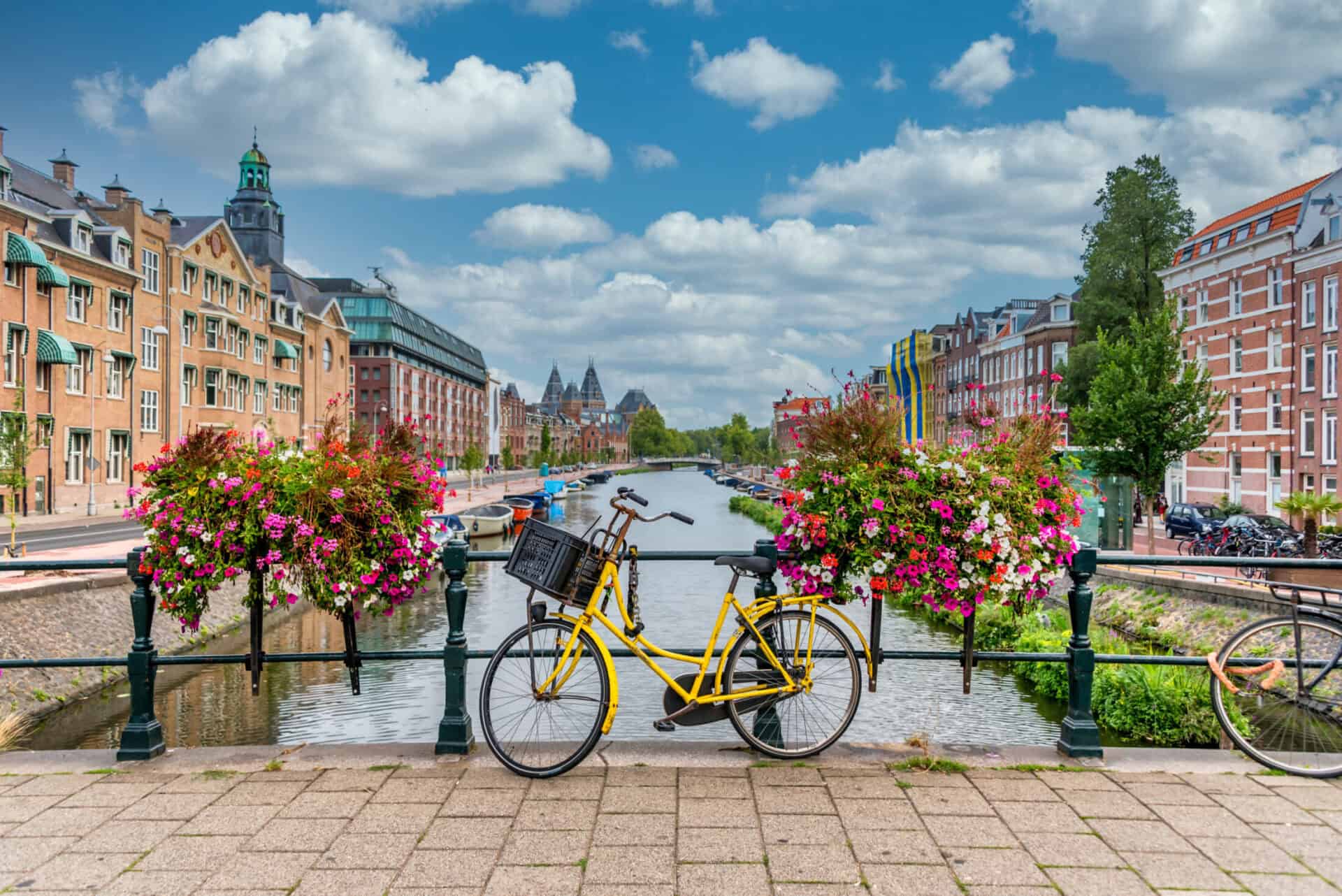 Scenic view of Berlin canal with colourful flowers and bicycles in Mitte district.