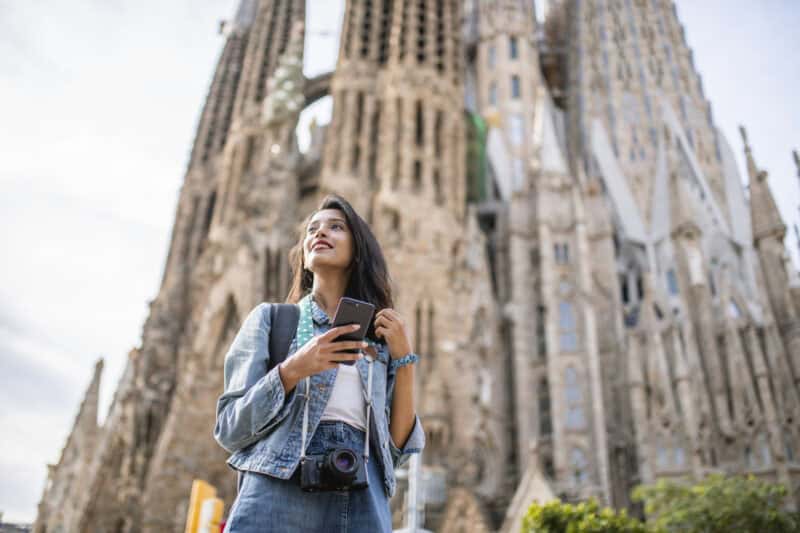 Young woman sightseeing near Berlin Cathedral, showcasing Mitte Hostel location in Berlin.