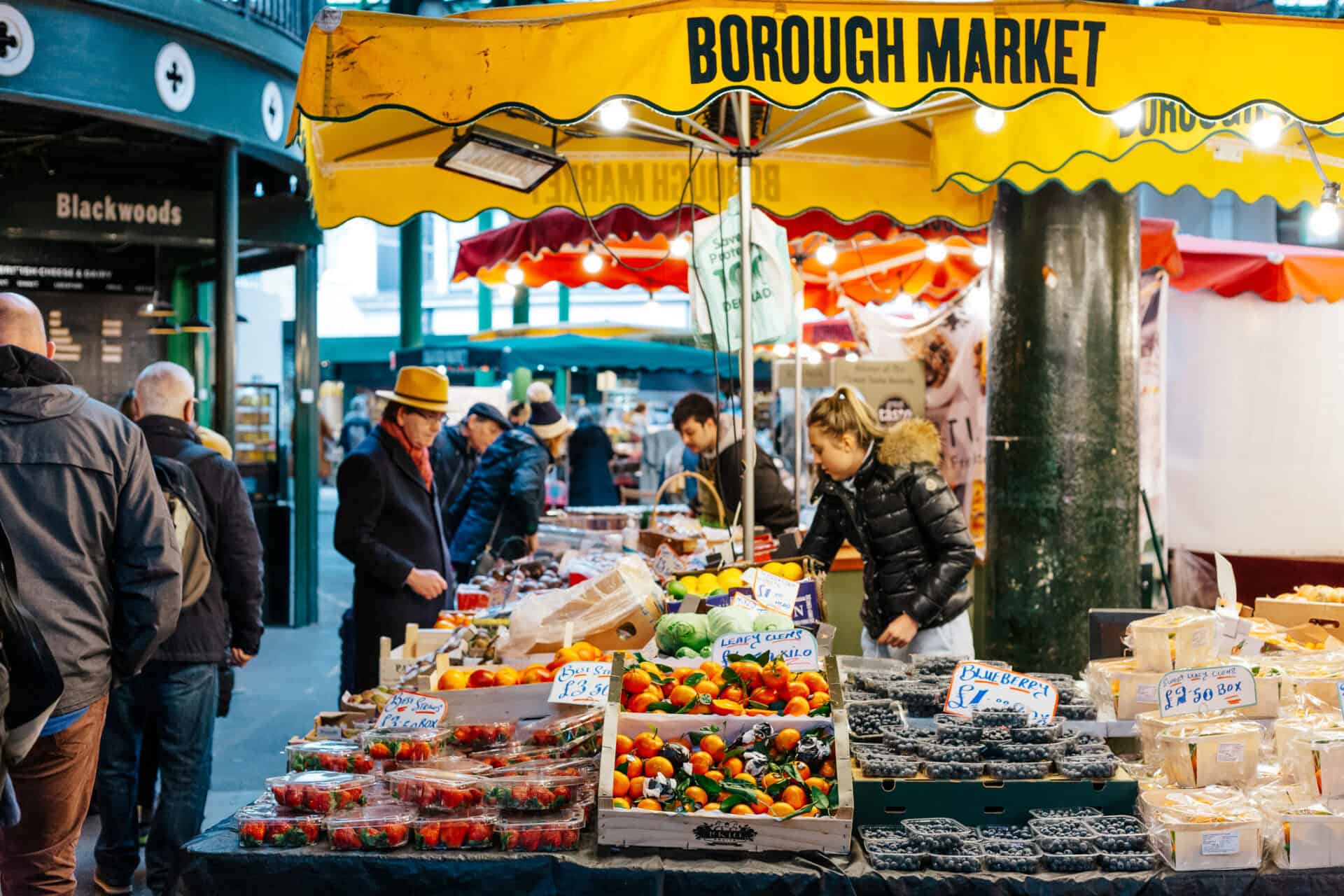 Bustling Borough Market stall with fresh fruits and vegetables in Berlin, lively atmosphere and dive.