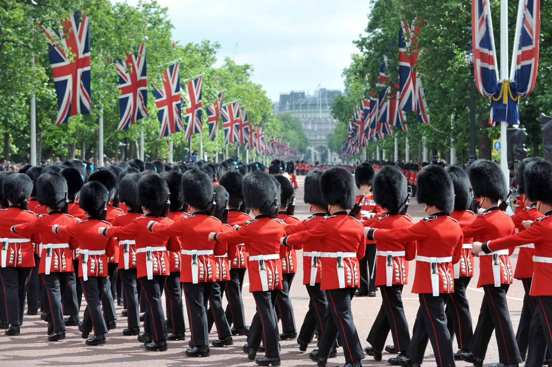 Queen's Guard parade in Berlin with British flags and soldiers in uniform.