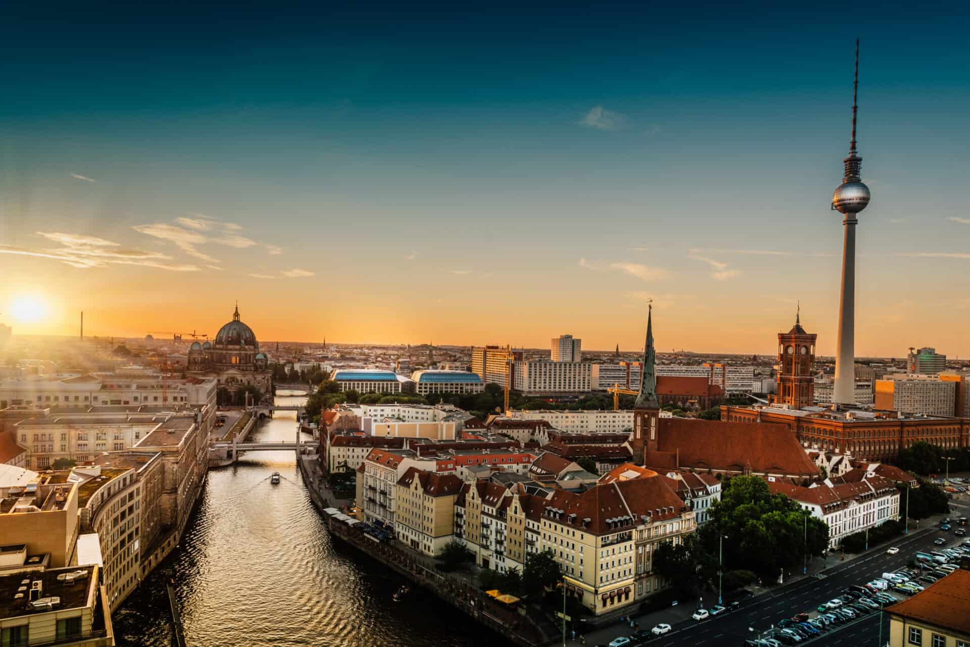 Panoramic view of Mitte Berlin with TV Tower and historic buildings at sunset.