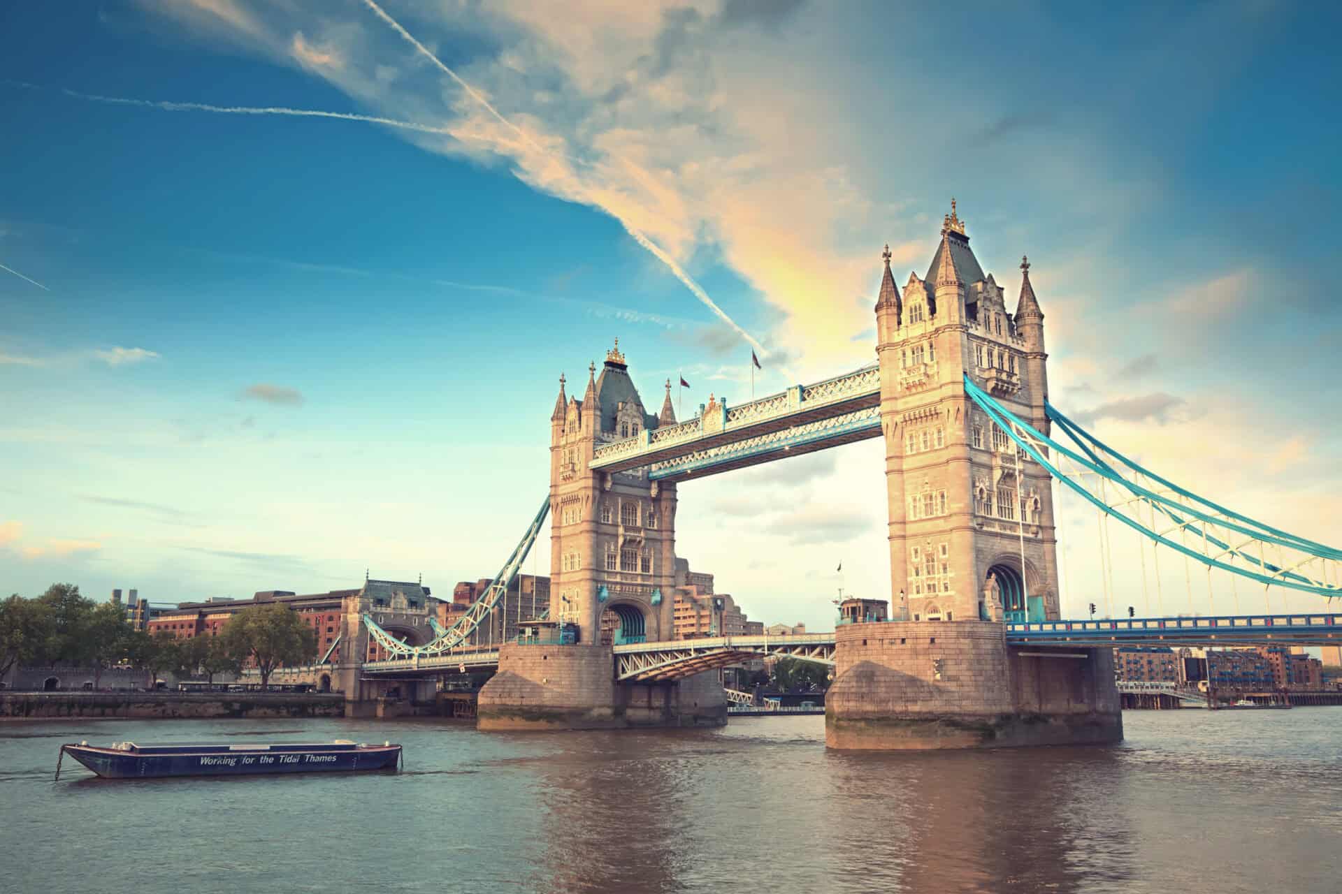 London Tower Bridge, a famous historic landmark, illuminated at sunset over the River Thames.