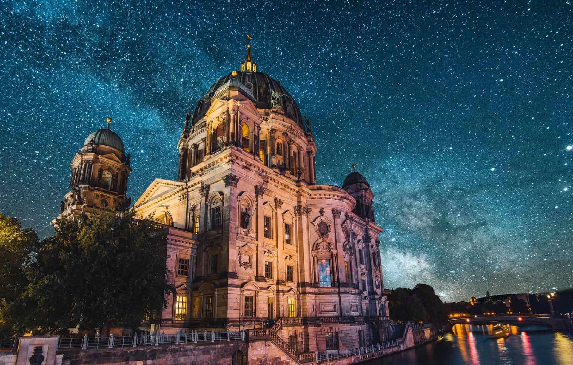 Berlin Cathedral illuminated against a starry night sky in Mitte, Berlin.