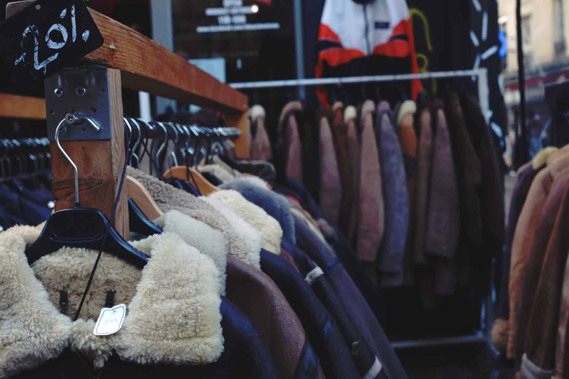 Coats and jackets hanging on racks at St Christopher’s Berlin hostel in Mitte.