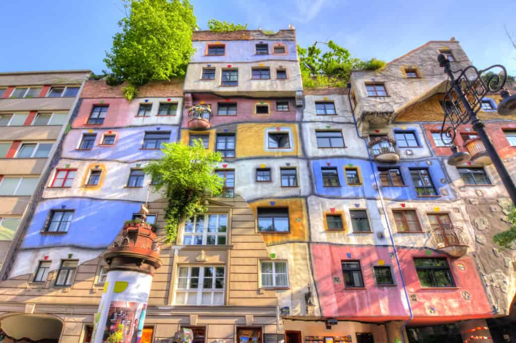 Colourful facade of Mitte Hostel in Berlin with vibrant murals and unique architecture.