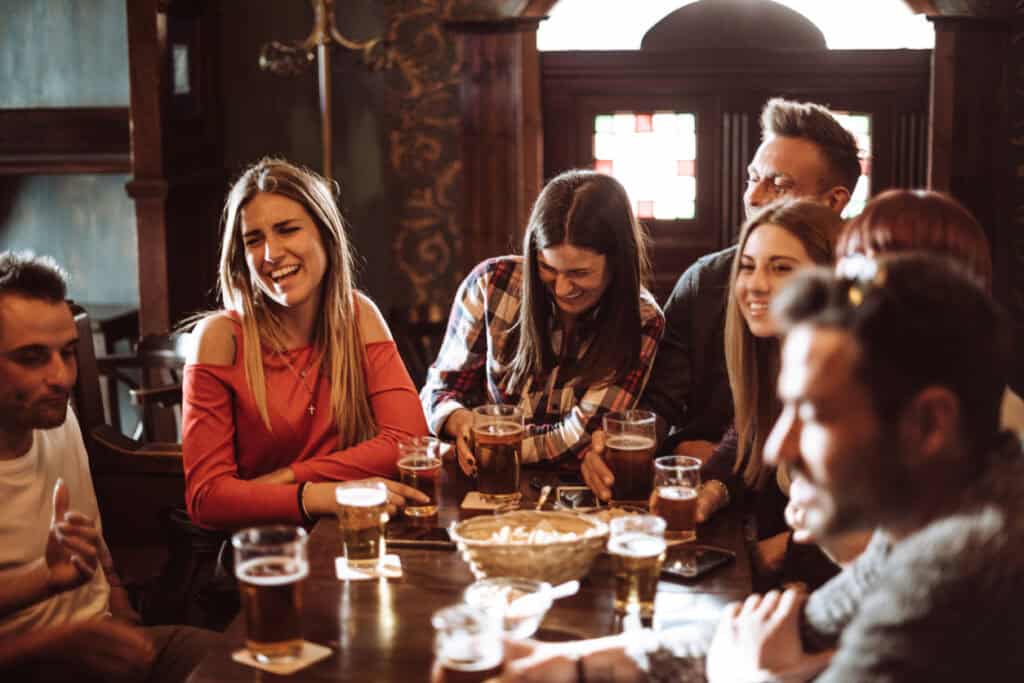 Group of young adults enjoying drinks at Mitte Hostel, Berlin.