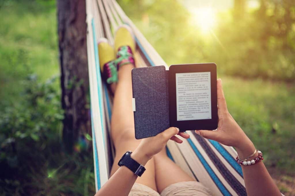 Relaxing in a hammock with an e-reader in Berlin's Mitte area, perfect for travellers seeking comfor.