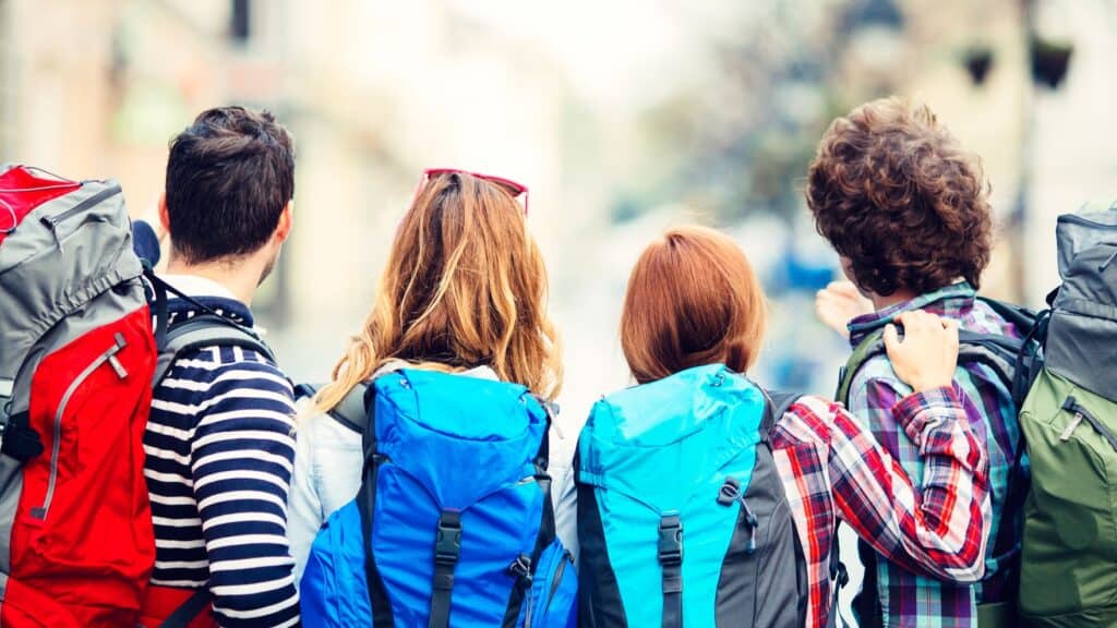 Group of young backpackers with colorful backpacks in Berlin Mitte.