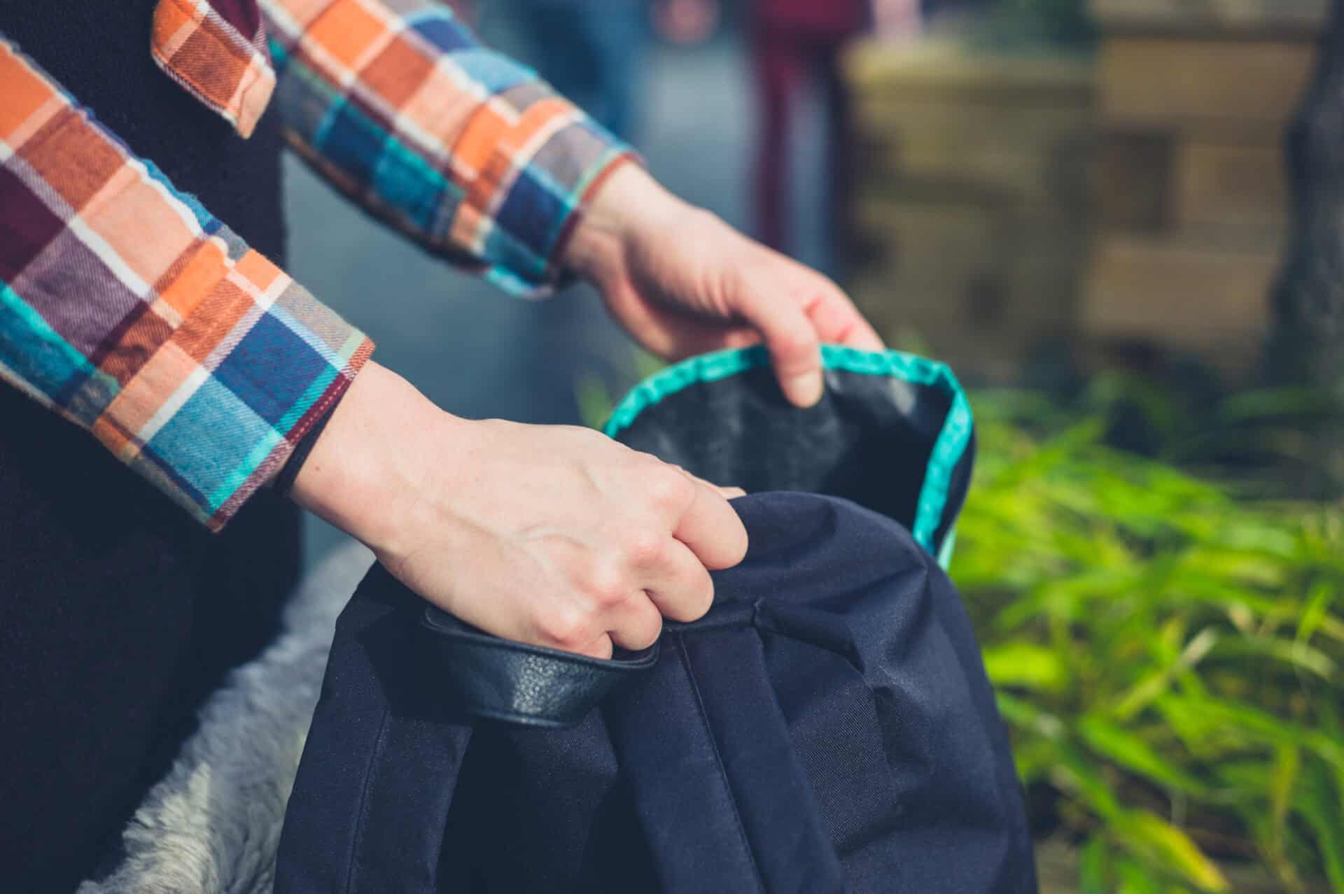 Person packing a backpack at Mitte Hostel Berlin, a popular accommodation for travellers.