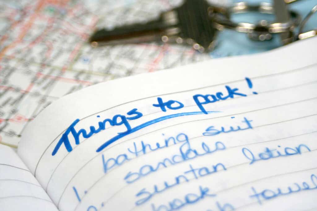 Brightly lit note with packing list for Berlin trip, including swimsuit and sunglasses.