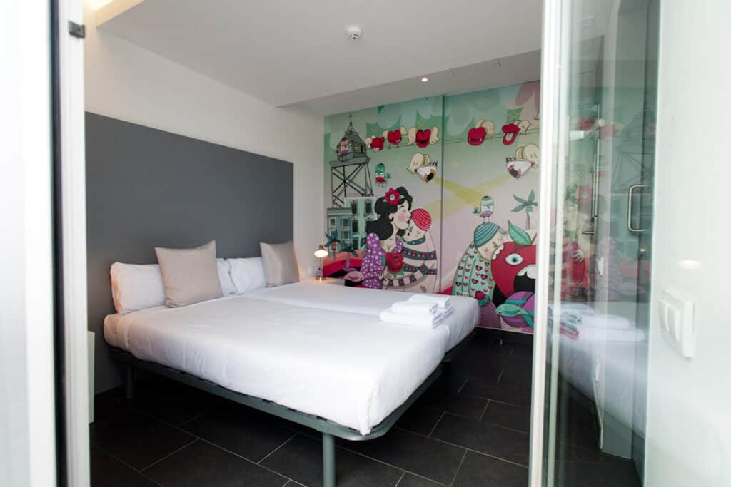 Modern hostel room with colourful mural wall art in Berlin Mitte.