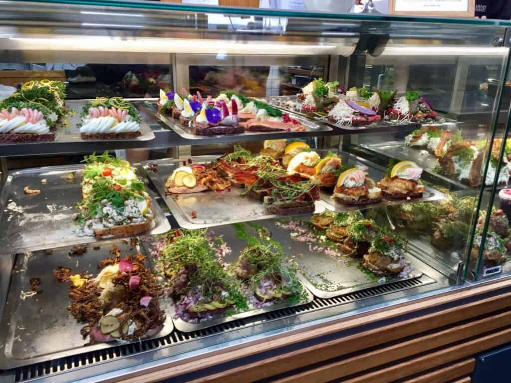 Desserts display at St Christopher’s Berlin - Mitte hostel showcasing a variety of colourful cakes a.
