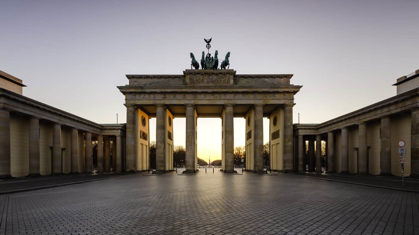 A historic archway with statues on top, symbolising Berlin's history.