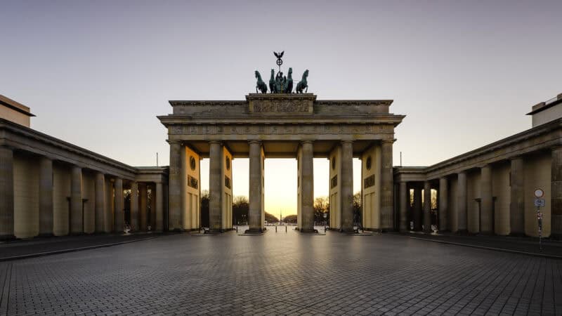 A historic archway with statues on top, symbolising Berlin's history.